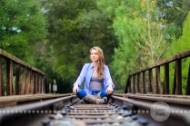 Connie Hanks Photography // ClickyChickCreates.com // sitting outdoors on train track in rustic park!