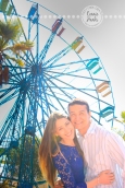 Connie Hanks Photography // ClickyChickCreates.com // engagement couple session, Rosarito, Mexico, mercado, market, colorful, turquoise, blue, gray, wood, wheel, rustic, arches, archways, kiss, ferris wheel, circus