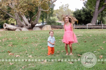 Connie Hanks Photography // ClickyChickCreates.com // Family Photography, Old Poway Park, rustic, park, train, tracks, grass, siblings, coordinated family, salmon, orange, pink, lovely